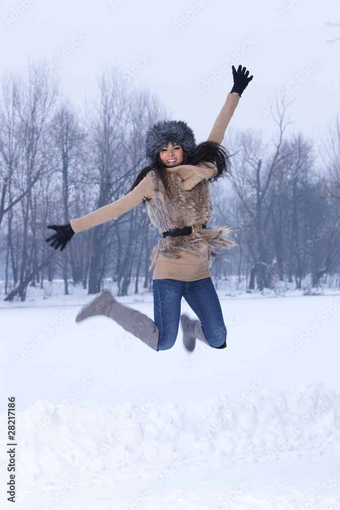 Woman jumping in snowy outdoor