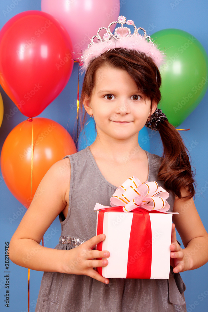 Little girl with balloons on blue background with present Little girl with balloons on blue background with present