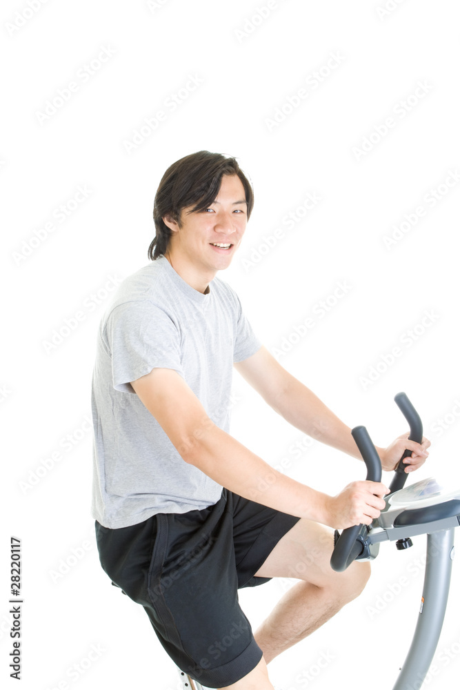 Asian Man Riding Exercise Bike Isolated on White Background Asian Man Riding Exercise Bike Isolated on White Background