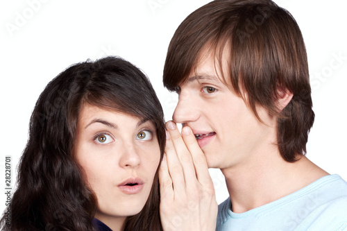 man telling a secret to girl on white background