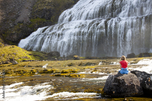 Relax on the rock. In background Dynjandi waterfall - Iceland
