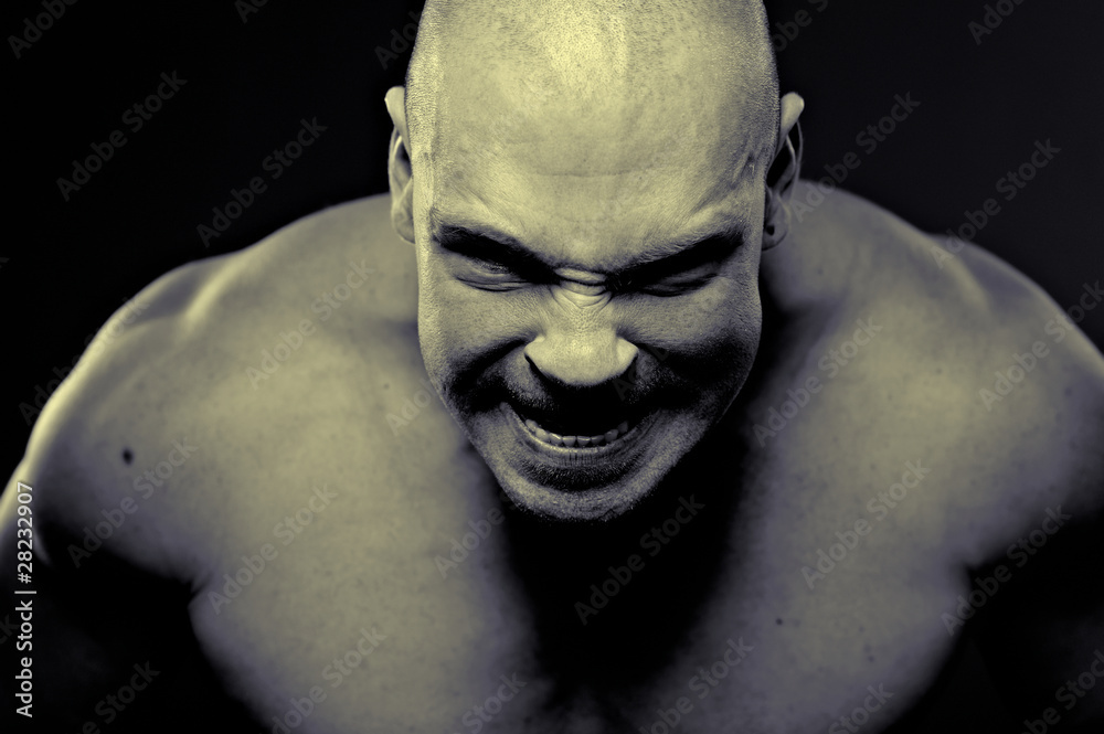 Emotional portrait of muscular aggressive man