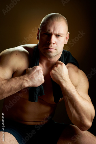 Muscular man, contrasty studio portrait