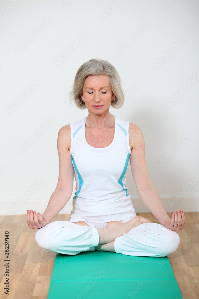 Senior woman doing yoga exercises Senior woman doing yoga exercises