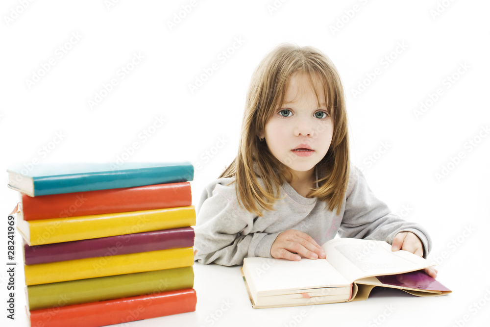 Beautiful girl with school books on the table, reading. Beautiful girl with school books on the table, reading.