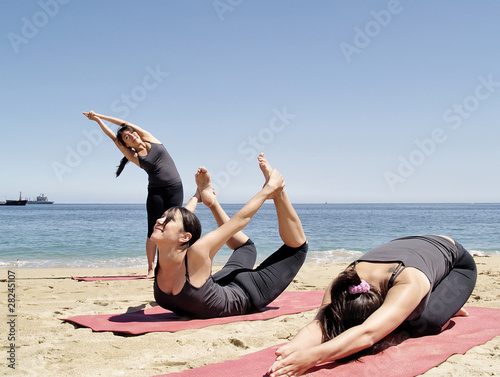 Composition of several bikram yoga poses at beach photo