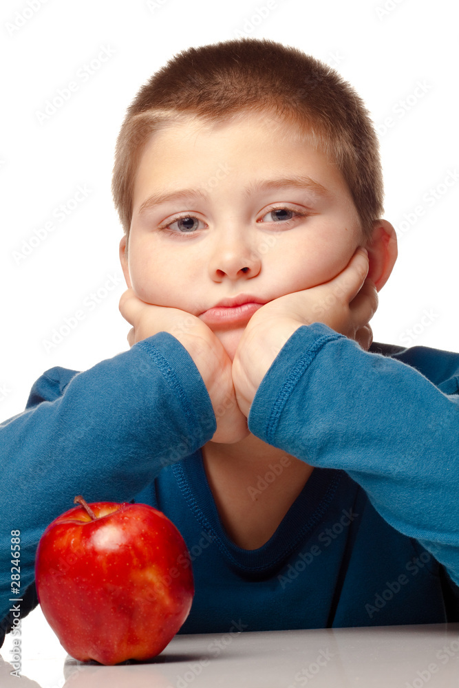 Young boy deciding to eat a healthy apple Young boy deciding to eat a healthy apple