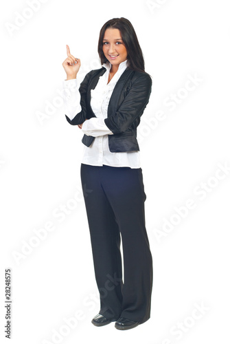 Young business woman pointing up