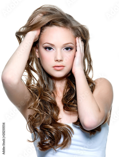 Beautiful teen girl with long curly hairs