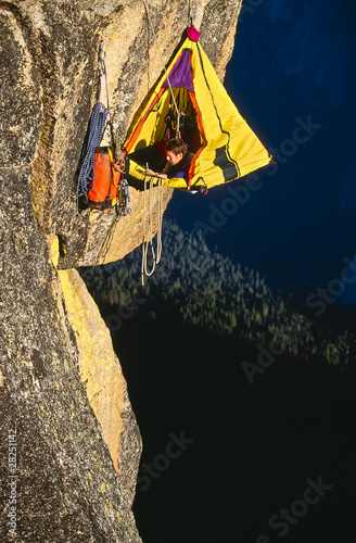 Rock climber bivouaced in a portaledge.