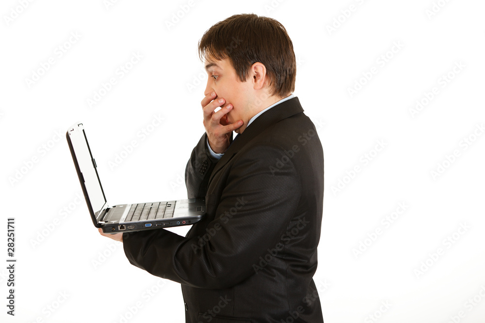 Shocked modern businessman  looking in laptops screen