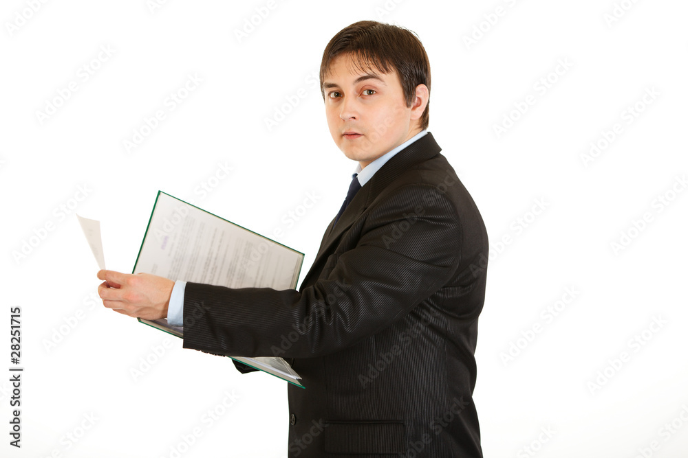 Serious modern businessman  holding folder with documents