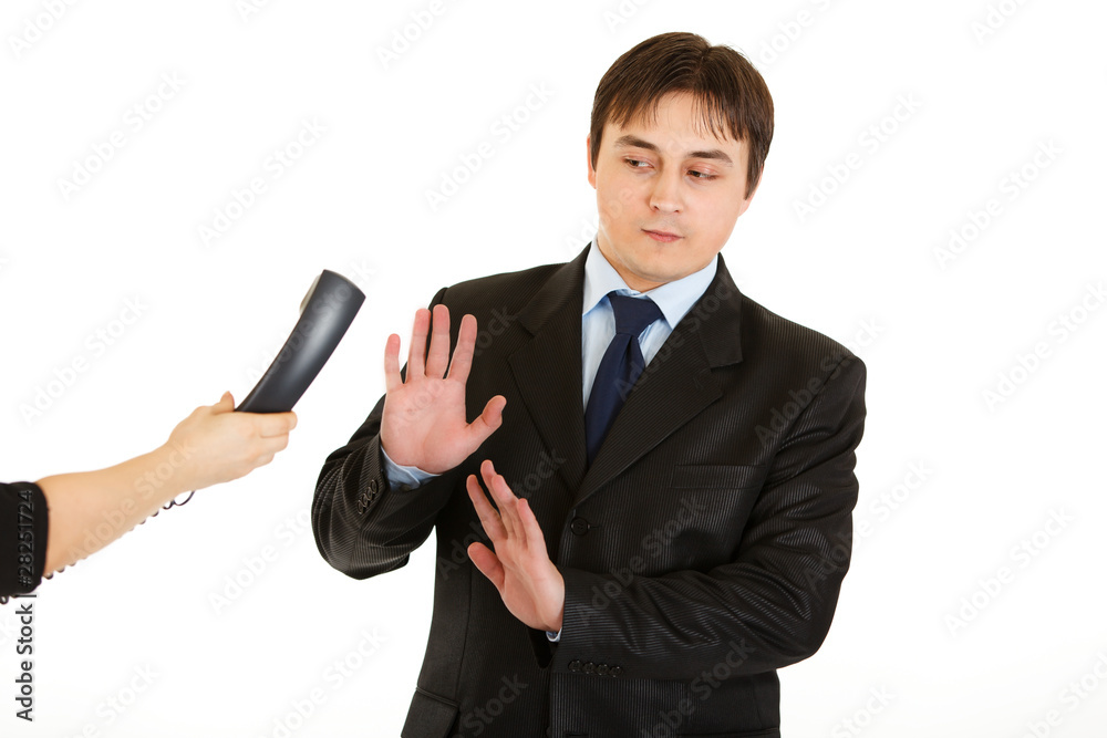 Very busy young businessman refusing to answer on phone call Very busy young businessman refusing to answer on phone call