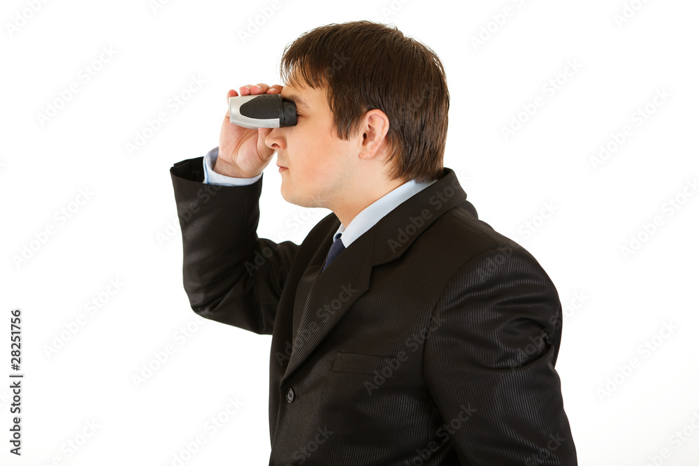 Interested young businessman looking through binoculars Interested young businessman looking through binoculars
