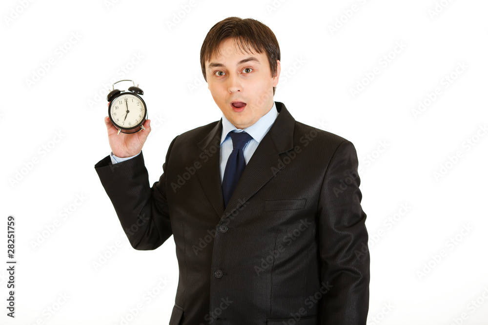 Shocked businessman holding alarm clock. Lost time concept. Shocked businessman holding alarm clock. Lost time concept.