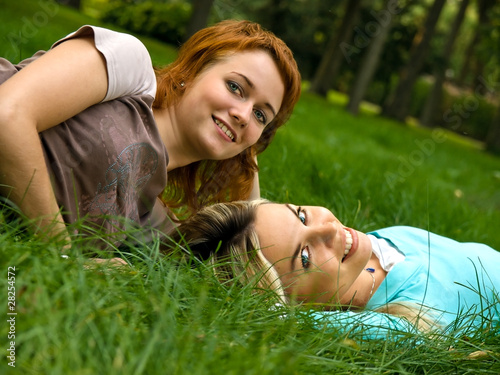 Two girls resting on the grass
