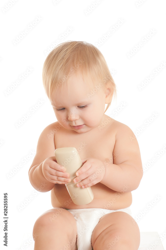 Portrait of happy young sitting baby with phone in hand Portrait of happy young sitting baby with phone in hand