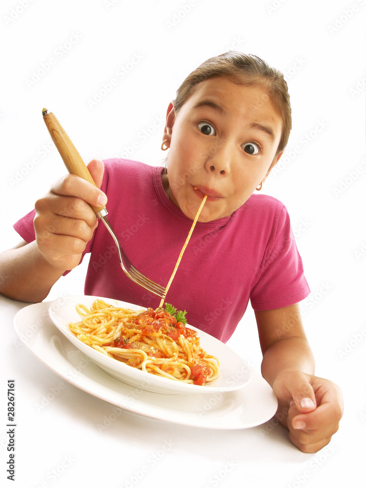 Funny little girl eating pasta on white background.
