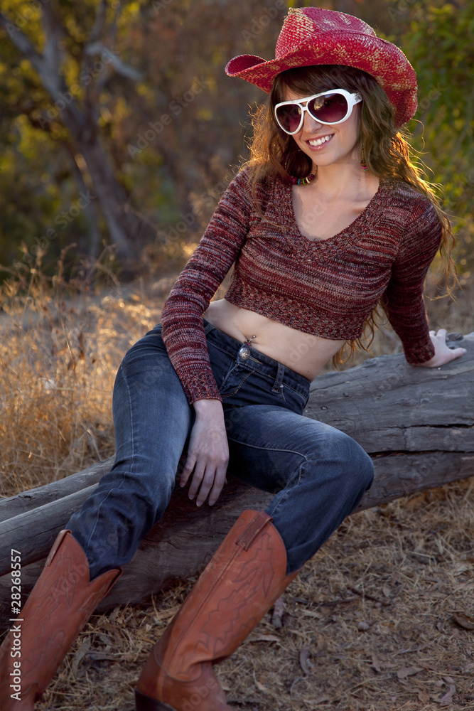 Outdoor cowgirl in blue jeans and boots Photos | Adobe Stock