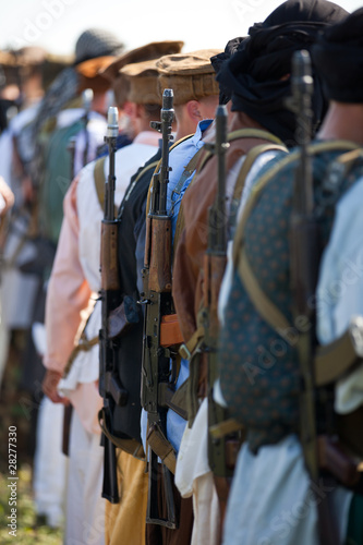 Men standing in row outdoors