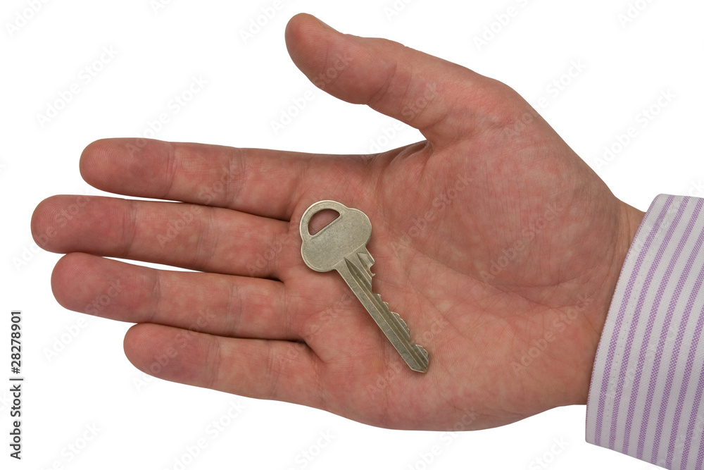 metal key in hand .isolated on white background metal key in hand .isolated on white background