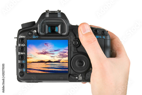 Hand with camera and beach landscape (my photo)