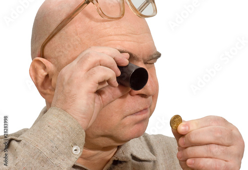 jeweler magnifier hands of a numismatist coin