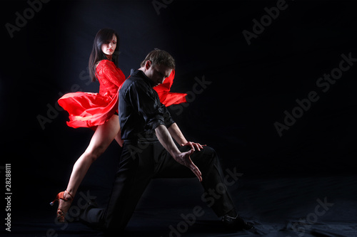 dancers in action against black background