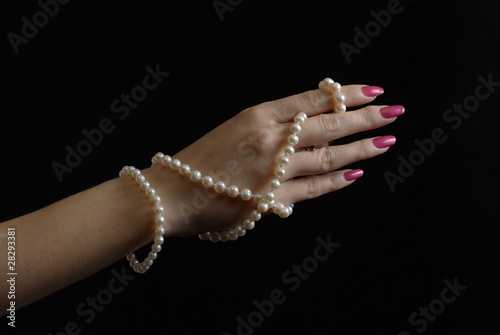Woman hand with pearl beads