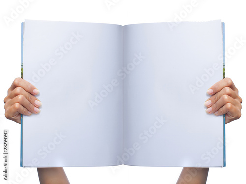gesture of womans hand holding white magazine