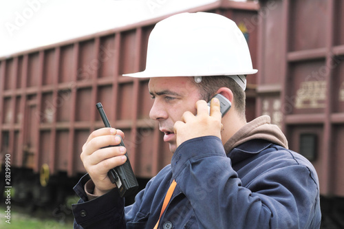 Young businessman calling on mobile phone, outdoor. photo