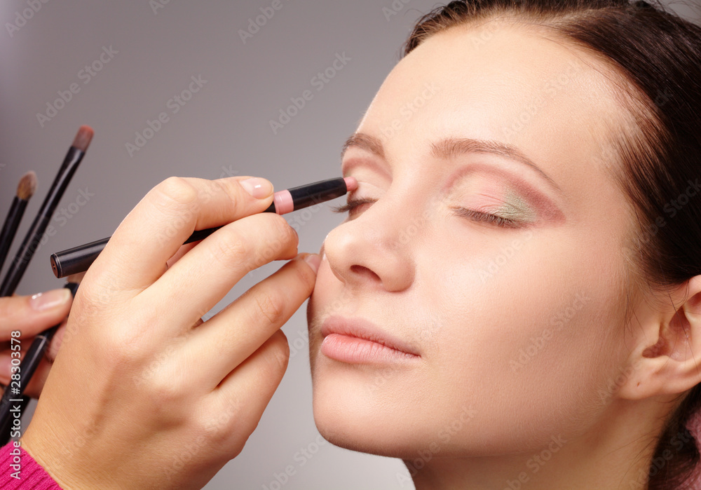 Applying eyeshadow for young girl