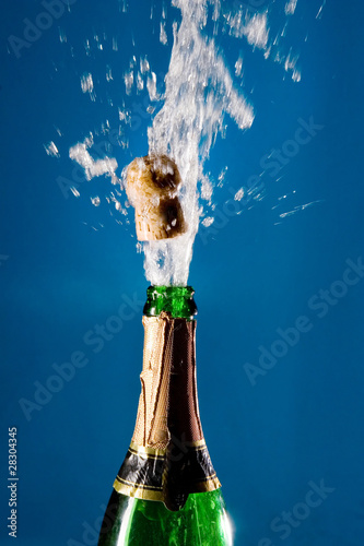 Bottle of champagne with a popping cork