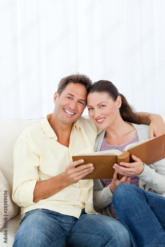 Portrait of a happy couple looking a photo album Portrait of a happy couple looking a photo album
