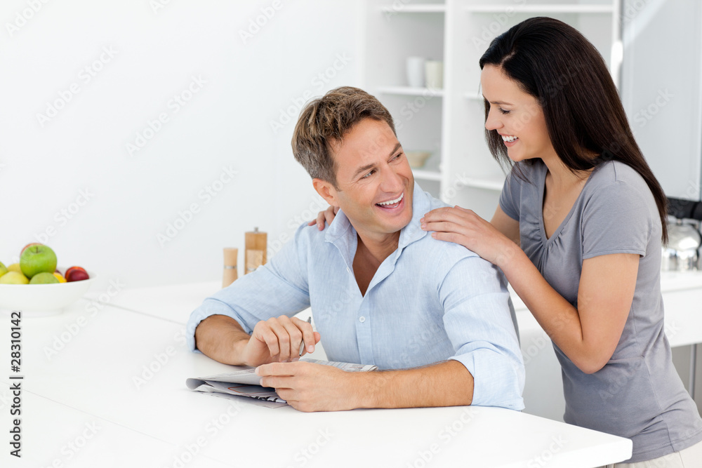 Happy couple doing a cryptic crossword together Happy couple doing a cryptic crossword together