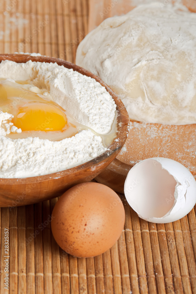 Flour, raw eggs and dough for making bread Flour, raw eggs and dough for making bread
