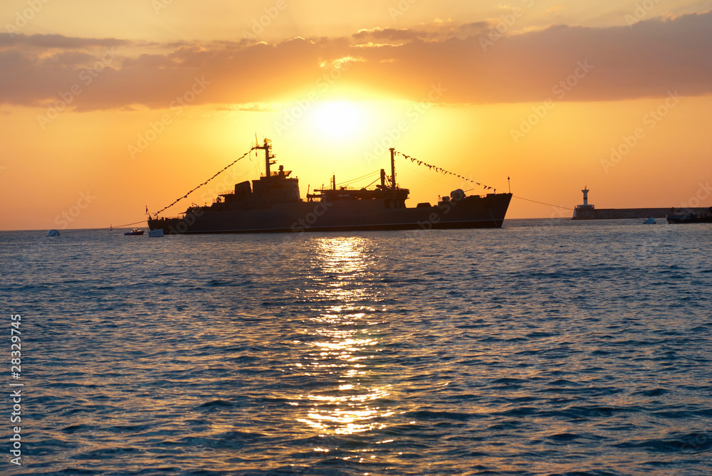 Military ship against sunset