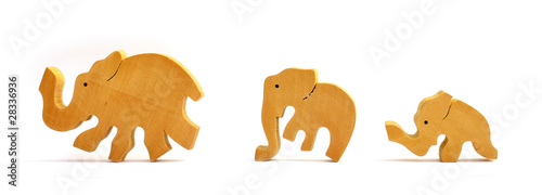 Photography Three wooden toy elephants marching in a row