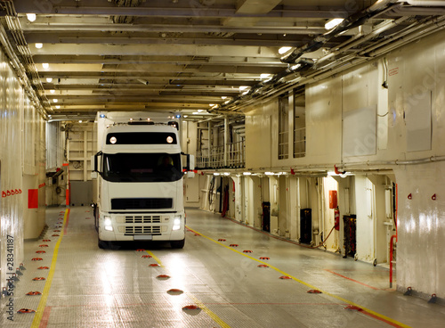 White truck on the cargo deck of the ferry