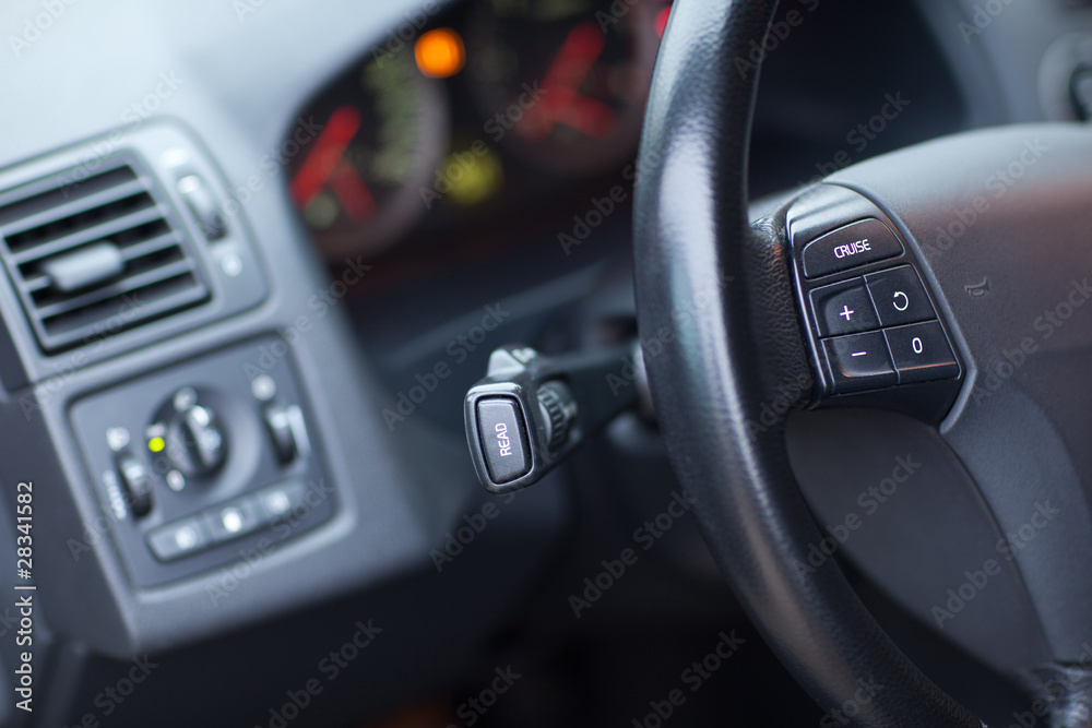 Modern car interior - detail of the steering wheel (shallow DOF