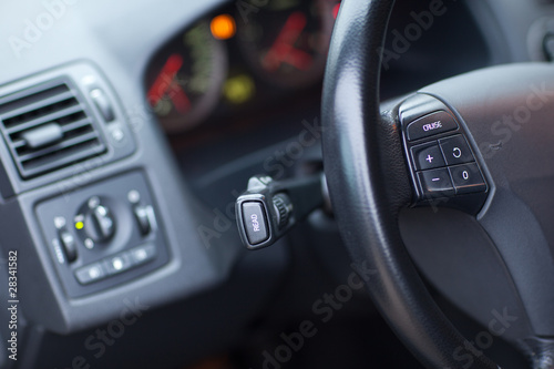 Modern car interior - detail of the steering wheel (shallow DOF