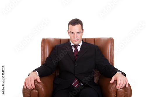Businessman seated on a chair