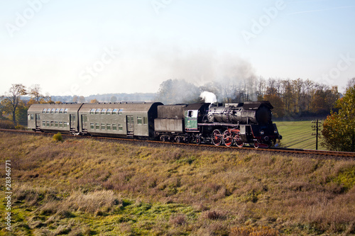 Vintage steam train starting from the station, wintertime