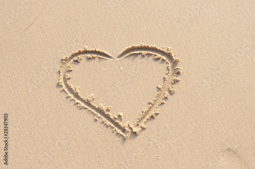 Heart symbol of love on the sand