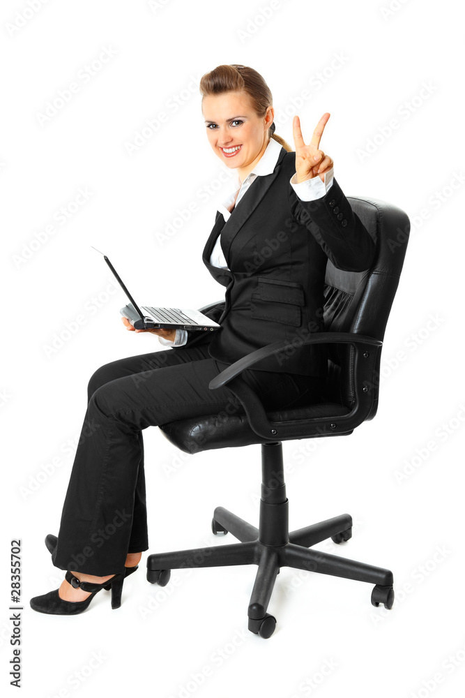 Business woman with laptop showing victory gesture Business woman with laptop showing victory gesture