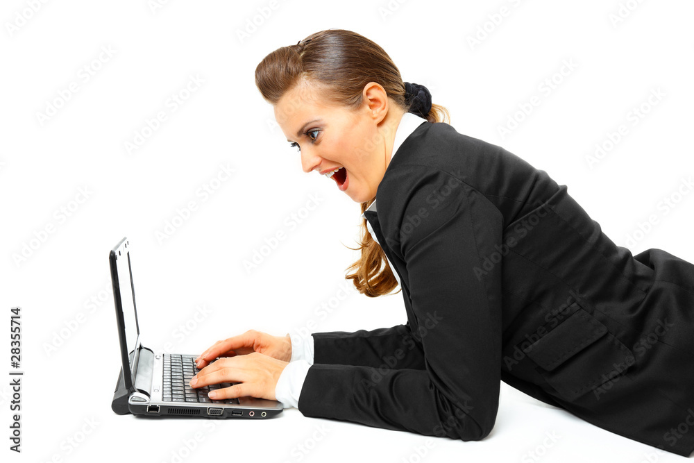 Laying on floor pleased modern business woman using laptop. Laying on floor pleased modern business woman using laptop.