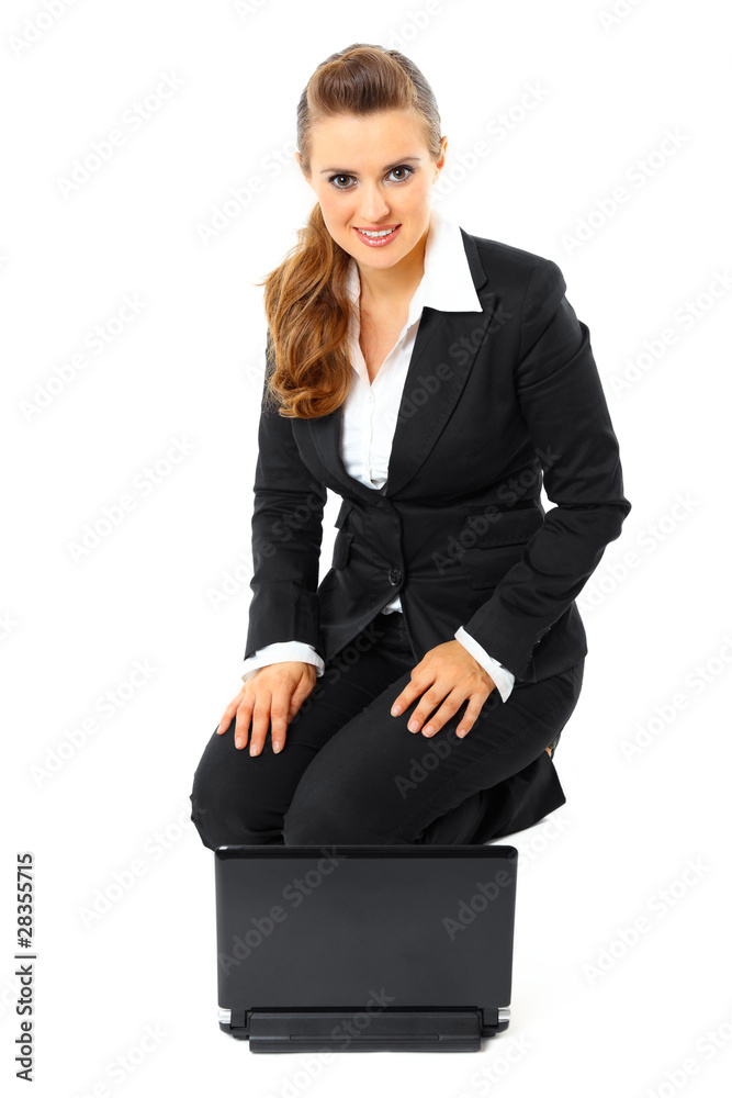 Smiling modern business woman sitting on floor with laptop. Smiling modern business woman sitting on floor with laptop.