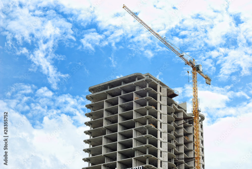 Building crane and not complete skyscraper Building crane and not complete skyscraper
