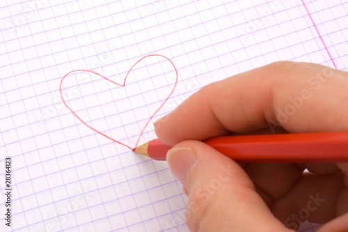 Hand draws the heart.