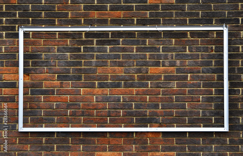 Rectangular metal frame on a brick wall